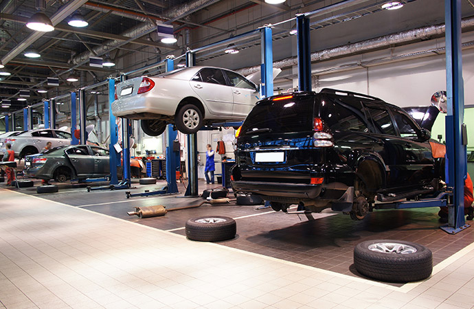 Cars getting repaired in auto body shop