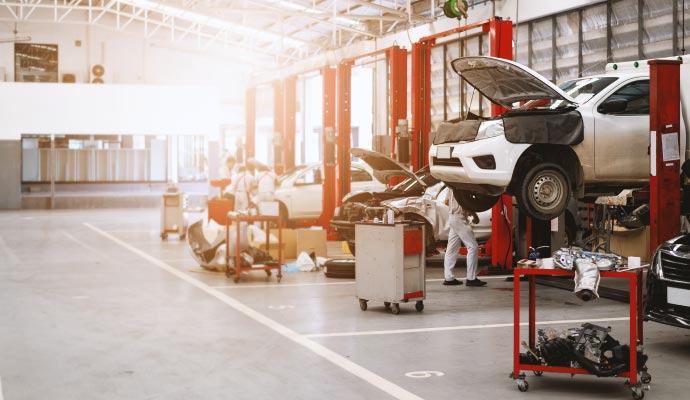 professional team working on restoring cars at the workshop