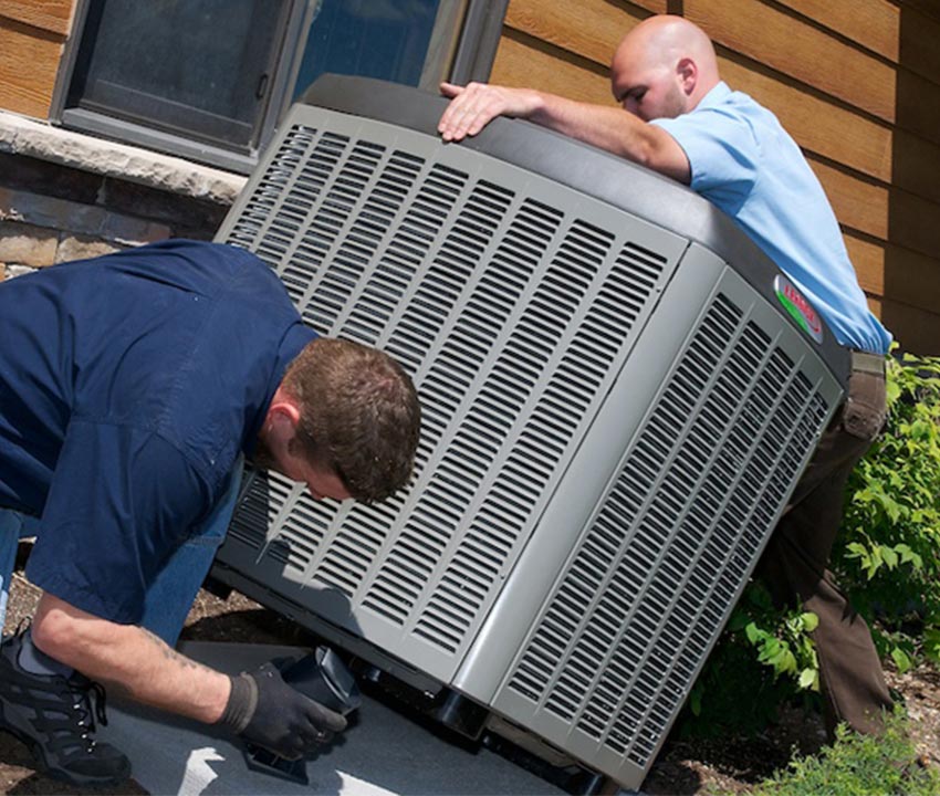 A couple of hvac professionals working on HVAC system