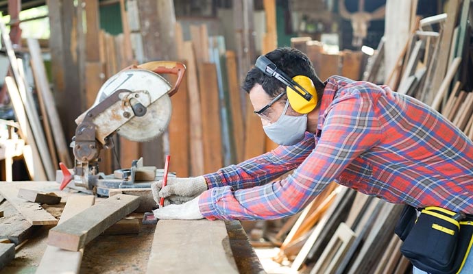 A profession carpenter is working in a woodworking shop