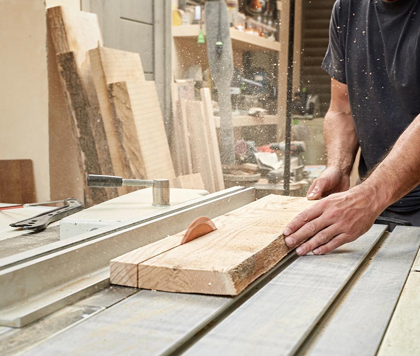 A professional carpenter working in a well-equipped workshop